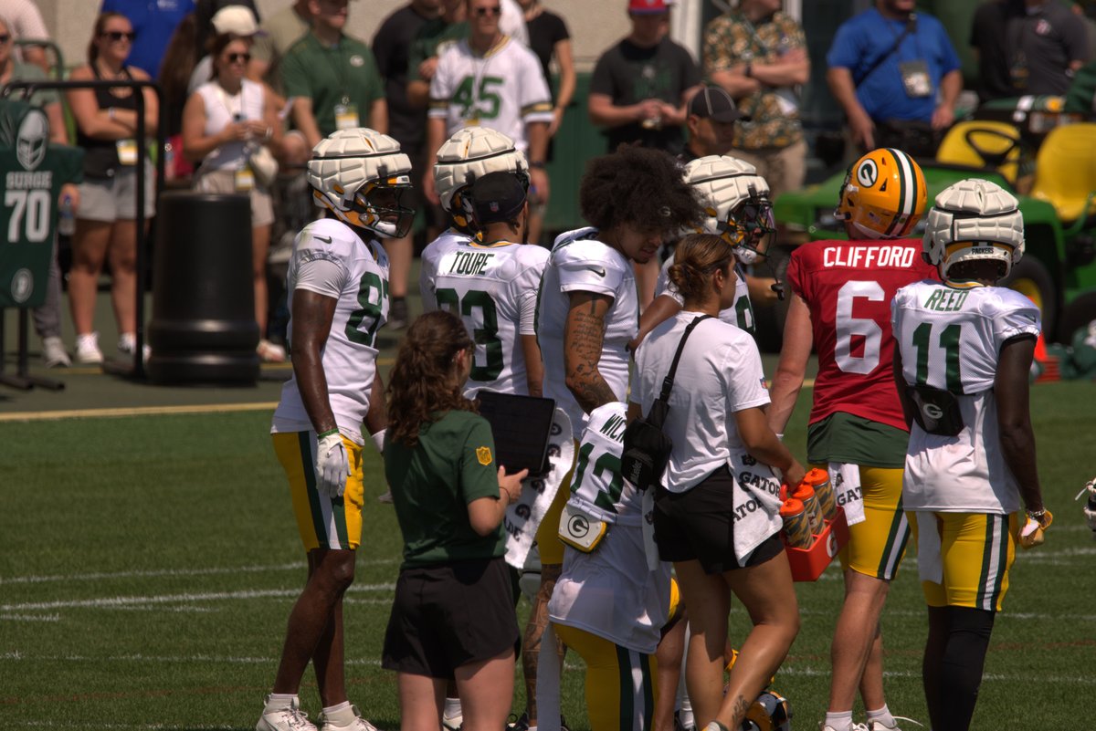 Christian Watson talking to Dontavion WIcks