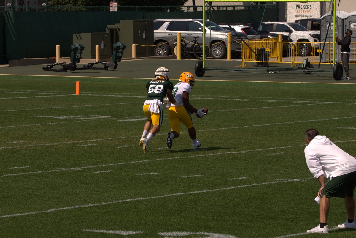 AJ Dillon catching a pass in front of Isaiah McDuffie